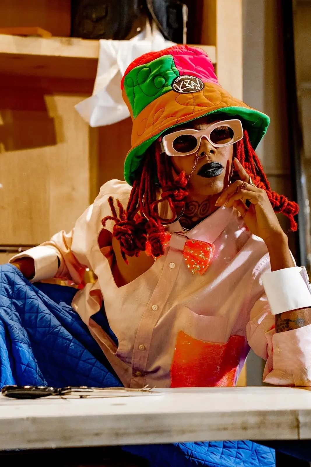 Ayşegül Ikna campaign image: model in an upcycled patchwork bucket hat and pink shirt