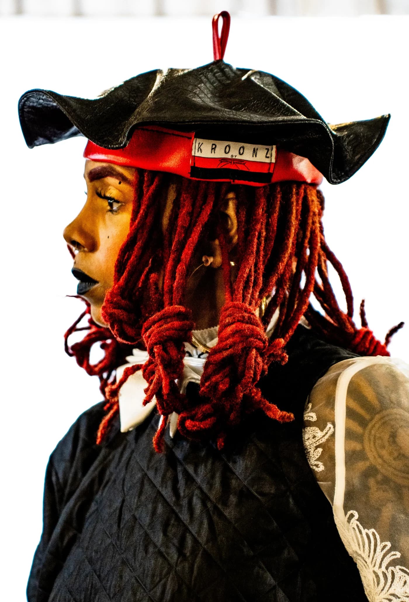 Ayşegül Ikna campaign image: model in profile wearing a reworked leather tricorn hat